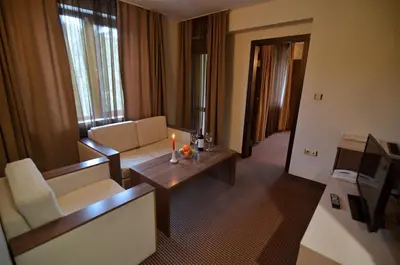 a living room with a couch and a table at Spa Hotel Kleptuza in Velingrad
