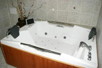 a bath tub with a laptop sitting on top of it at Spa Hotel Kleptuza in Velingrad