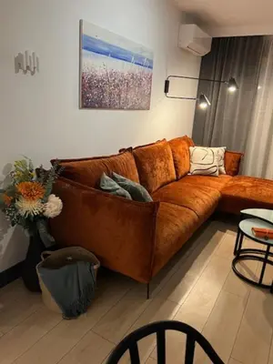 a brown leather couch in a living room at Hotel Kardinal in Blagoevgrad