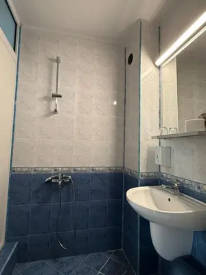 a bathroom with a shower and a sink at Family Hotel Studio in Sandanski