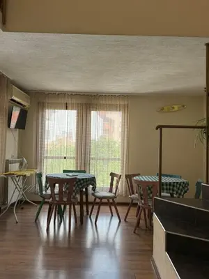 a dining room with a table and chairs at Family Hotel Studio in Sandanski