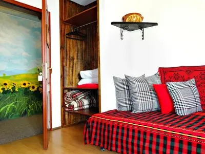 a bedroom with a bed with a plaid blanket at Hotel Simona Complex in Sofia