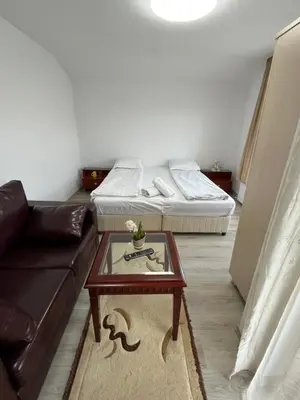a living room with a couch and a coffee table at Bayrakova Guest House in Dobrinishte