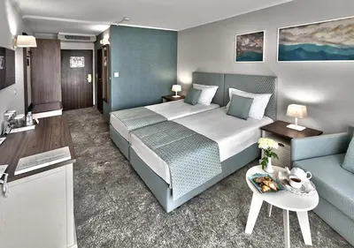 a hotel room with a bed and a couch at Interhotel Sandanski in Sandanski