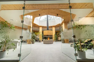 a lobby with potted plants in a building at Spa Hotel Orbita in Blagoevgrad