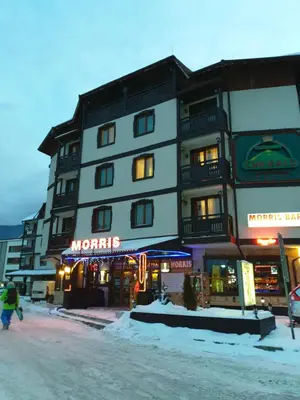 a large building on the side of a street at Simonen Apartments near the Gondola in Bansko