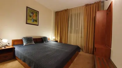 a bedroom with a bed and a large window at Simonen Apartments near the Gondola in Bansko