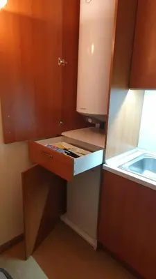 a kitchen with a counter with a drawer and a sink at Simonen Apartments near the Gondola in Bansko
