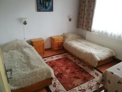 a room with two beds and a window at Guest Rooms Metaksinovi in Chepelare