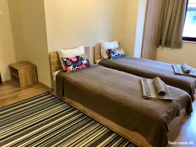a room with two beds and a couch at SKYLER GUEST HOUSE in Plovdiv