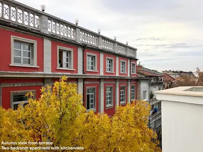 a red building with a balcony on top of it at SKYLER GUEST HOUSE in Plovdiv