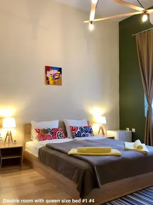 a bedroom with a bed with pillows on it at SKYLER GUEST HOUSE in Plovdiv