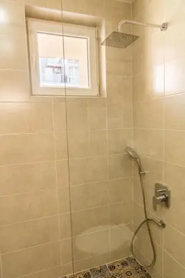 a bathroom with a shower with a glass door at Antique Residence in Hisarya
