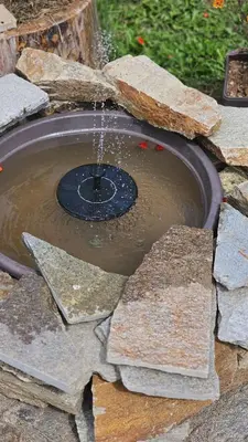 a fire hydrant with water shooting out of it at Панорама Стойките Уют in Stoykite