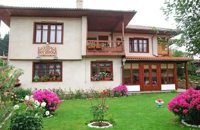 a house with flowers in front of it at Guest House Bolyarka in Koprivshtitsa