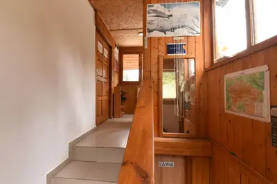 a hallway of a wooden building with stairs and windows at Къща Семково in Semkovo