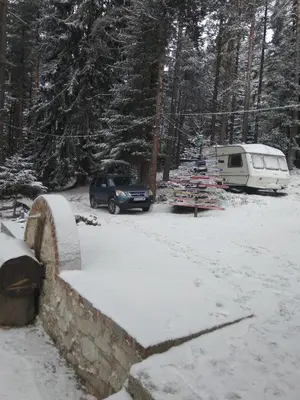 a snow covered parking lot with a camper and a tent at Къща Семково in Semkovo