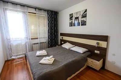 a bedroom with a bed with two towels on it at Belvedere Holiday Club ...VIP ap. in Bansko