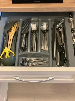 a drawer filled with utensils in a cabinet at Belvedere Holiday Club ...VIP ap. in Bansko