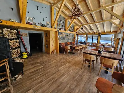 a dining room with tables and chairs in a restaurant at Algara hut in Panichishte
