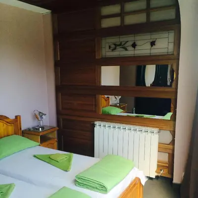 a bedroom with a bed and a mirror at Pop Bogomil family hotel in Sofia