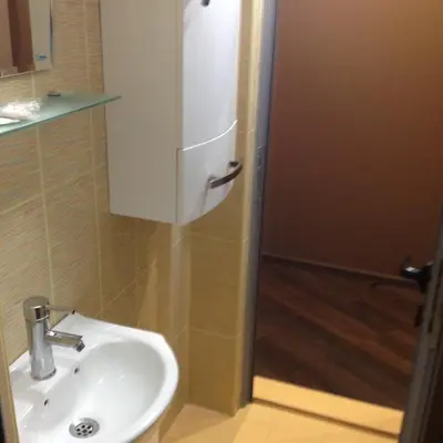 a white sink in a bathroom with a shower at Mountain Dreams Apartment in Sapareva Banya