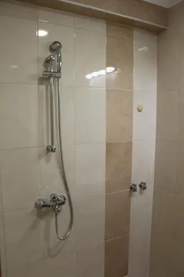 a shower in a bathroom with a glass door at Къща за гости Мишурови in Smolyan
