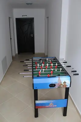 a large foosball table in a room with many bats at Къща за гости Мишурови in Smolyan