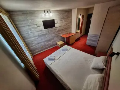 a hotel room with a bed and a tv at Korona Hotel in Blagoevgrad