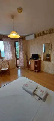 a bedroom with a bed with two towels on it at Family Hotel Emaly 1 in Bankya