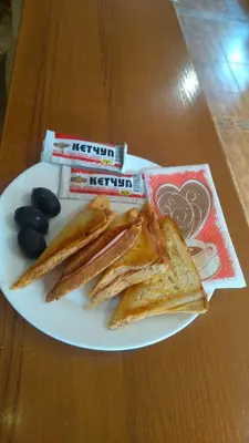 a plate of food with toast and raisins at Family Hotel Emaly 1 in Bankya