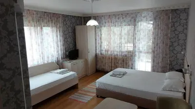 a small bedroom with two beds and a window at Family Hotel Emaly 1 in Bankya