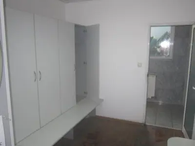 a bathroom with white cabinets and a mirror at Germanea Hotel in Sapareva Banya
