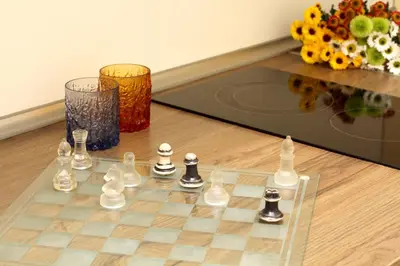 a chess board and two vases and flowers on a table at Central Charming Home with Garden near Parking and NDK in Sofia