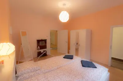 a bedroom with a large bed in a room at Central Charming Home with Garden near Parking and NDK in Sofia