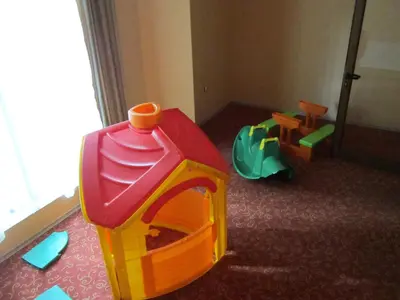 a childs play room with a toy house and chairs at Хотел Магнолия, Hotel Magnoliya in Panichishte