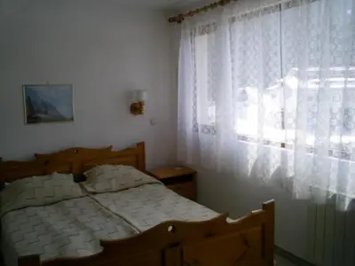 a bedroom with a bed and a window at Family Hotel Markony in Pamporovo