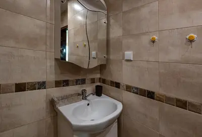 a bathroom with a sink and a mirror at RIVERSIDE APARTMENTS PLOVDIV with free parking in Plovdiv
