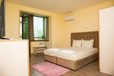 a small bedroom with a bed and a television at RIVERSIDE APARTMENTS PLOVDIV with free parking in Plovdiv