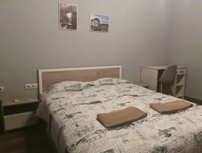 a bedroom with a bed with two towels on it at Panorama Rooms in Sofia