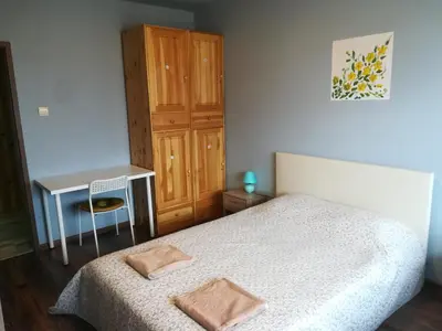 a small bedroom with a bed and a desk at Panorama Rooms in Sofia