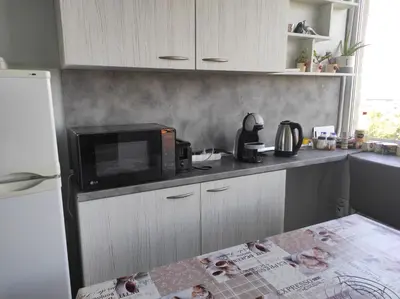 a kitchen with a microwave and a counter top at Panorama Rooms in Sofia
