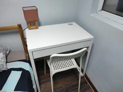 a white desk with a chair next to a bed at Panorama Rooms in Sofia