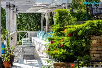a greenhouse with flowers and plants on a patio at Chiflika Family Hotel in Asenovgrad