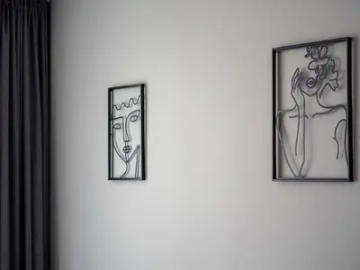 three framed pictures of women on a wall at Modern Apartment with Parking next to Bulgaria Mall in Sofia