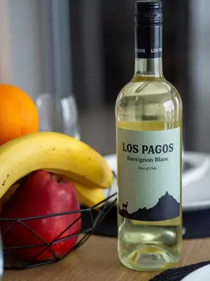 a bottle of los pasosemption sauce next to a bowl of fruit at Modern Apartment with Parking next to Bulgaria Mall in Sofia