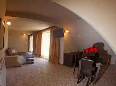 a living room with an archway and a living room with a couch at Vitoshko Lale Hotel in Sofia