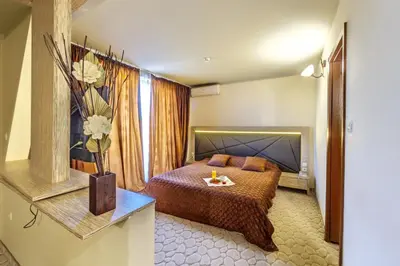 a hotel room with a bed and a window at Vitoshko Lale Hotel in Sofia