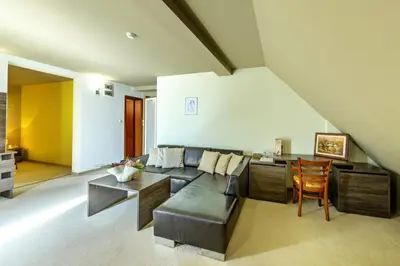 a living room with a couch and a table at Vitoshko Lale Hotel in Sofia