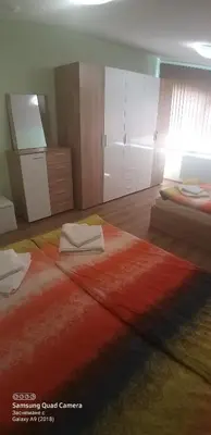 a bedroom with a large bed with towels on it at Apartments DIEM in Samokov